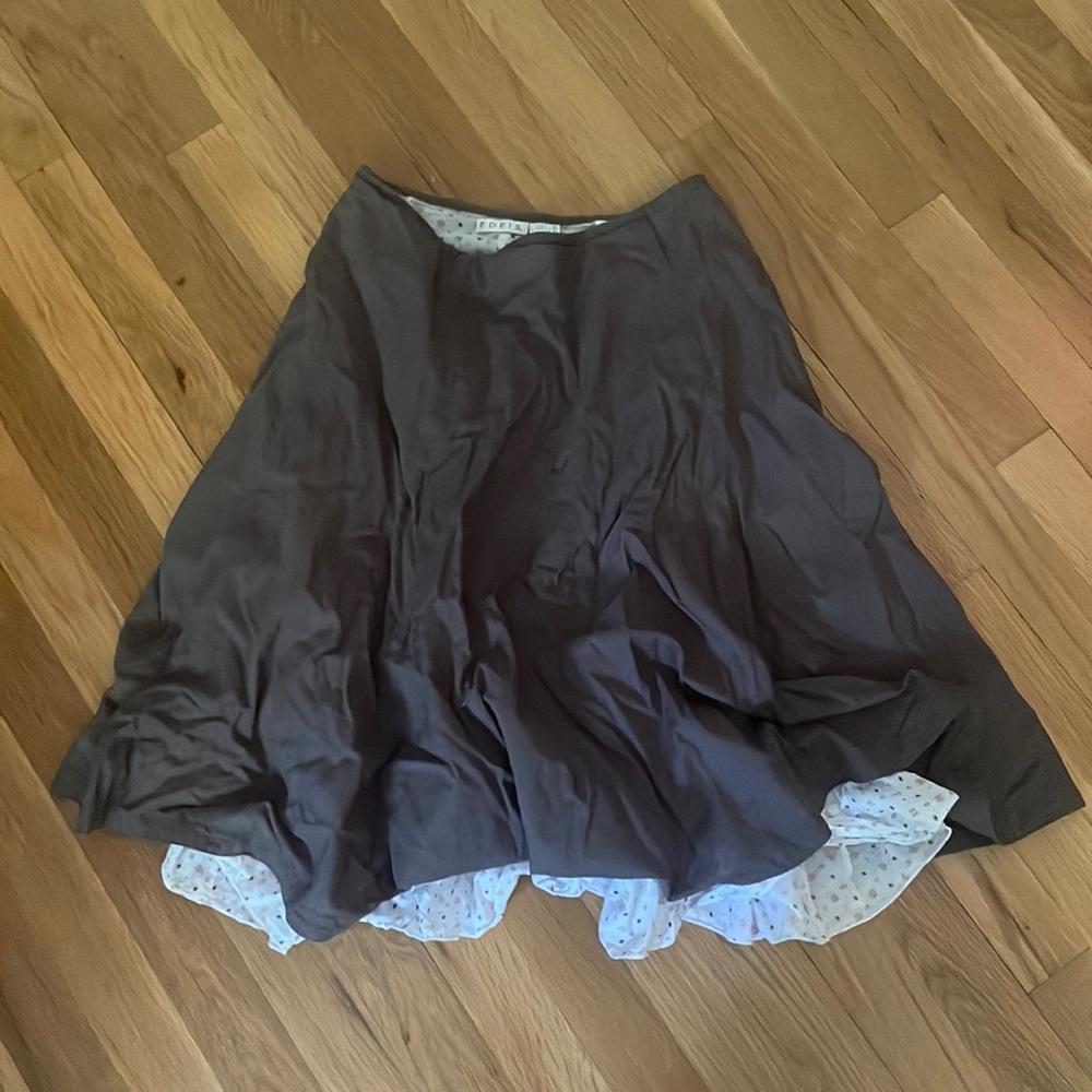 Brown skirt with white backround and pink and brown shapes underneath.
